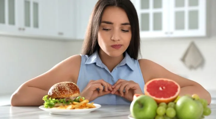 woman looking at a burger