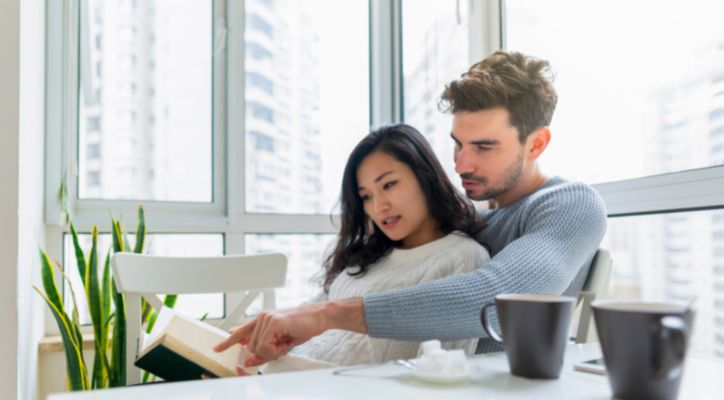 man and woman reading a book