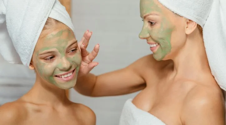 an image of 2 ladies with skincare on their face