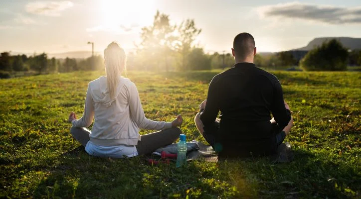 man and woman doing meditation