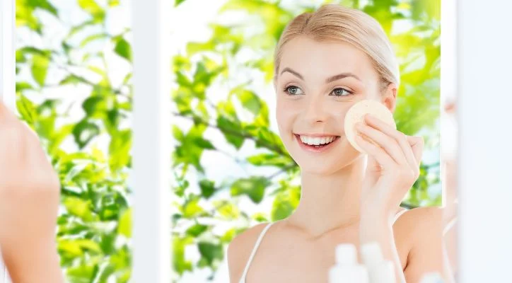 woman applying cream on her face in the morning