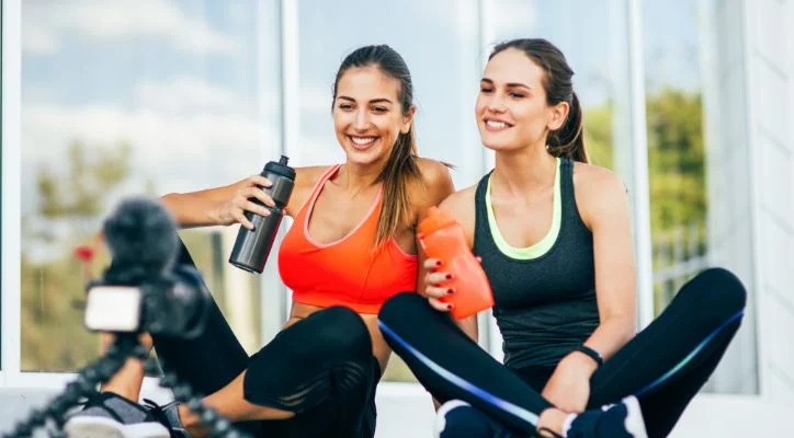 2 ladies handling a bottle of water